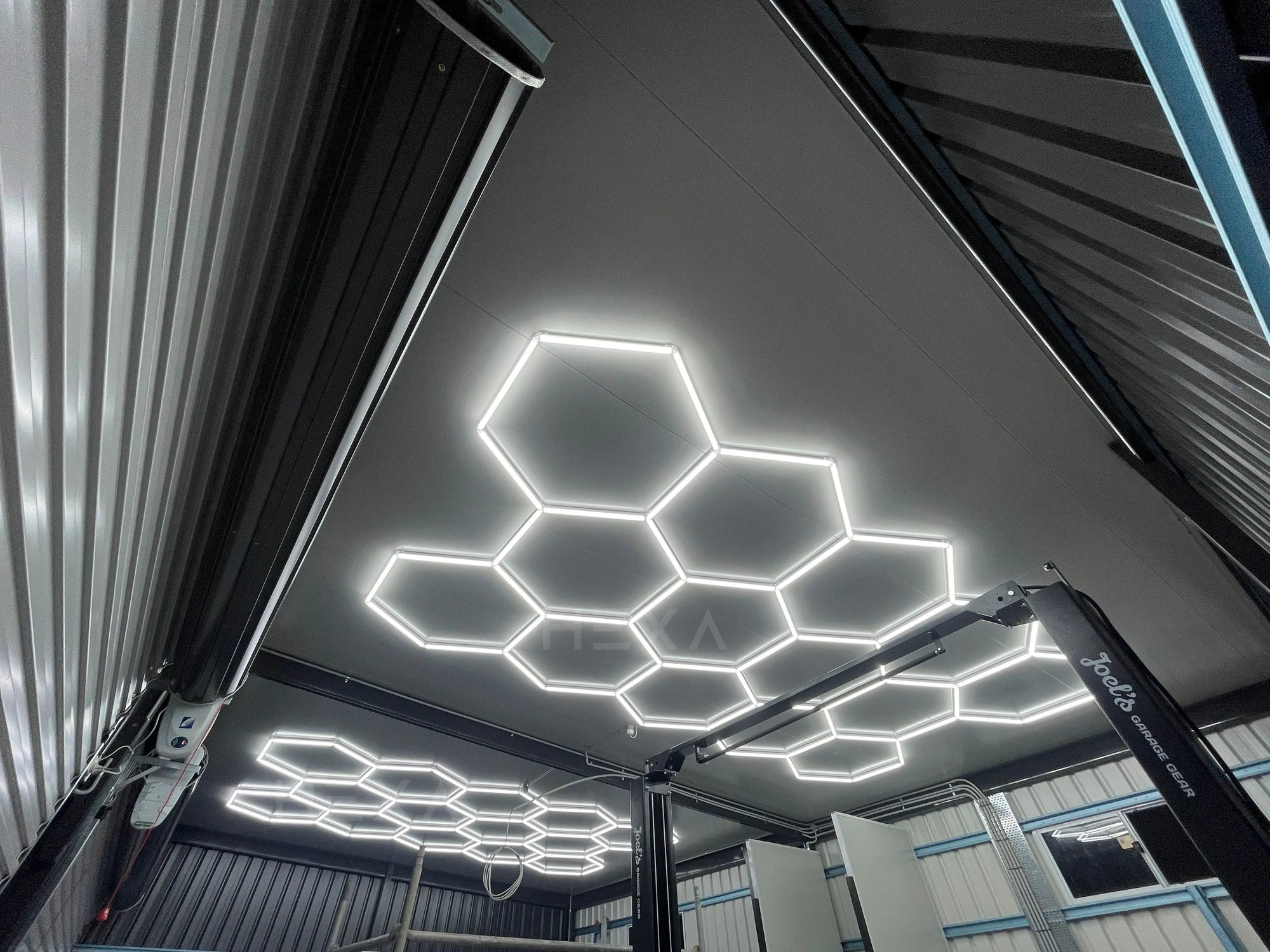 Real HEXA single garage hexagon LED lighting installation showing full ceiling coverage and cluster arrangement