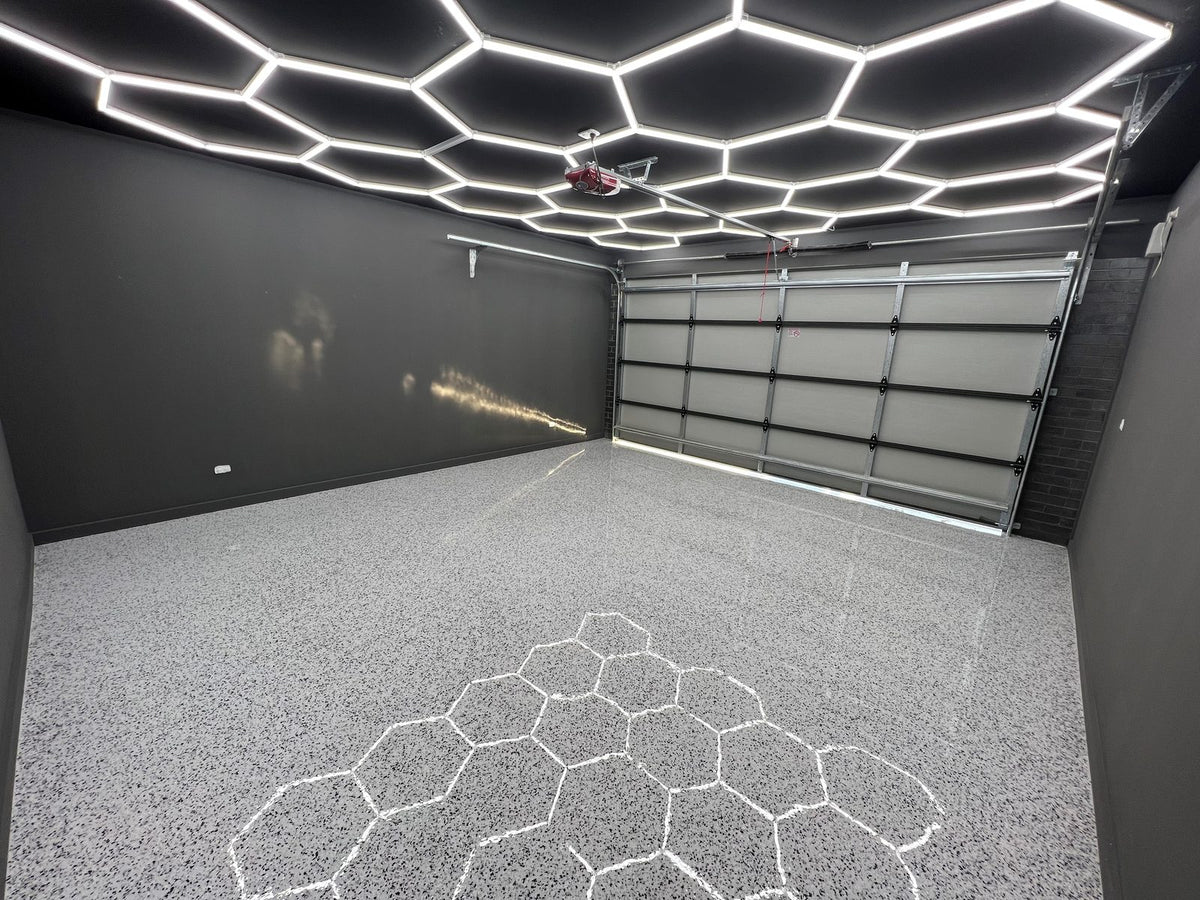 Linked HEXA hexagon LED panels lighting the ceiling of an Australian double garage shed, evenly lit above an epoxy floor